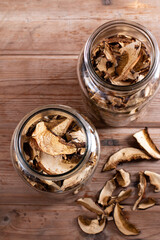 Dried mushrooms. Mushrooms in jar on the wooden table. Top view