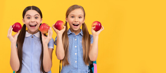 Eat fruit to be cute. Happy school friends hold apples. Healthy eating. Always eat right. Child girl portrait with apple, horizontal poster. Banner header with copy space.