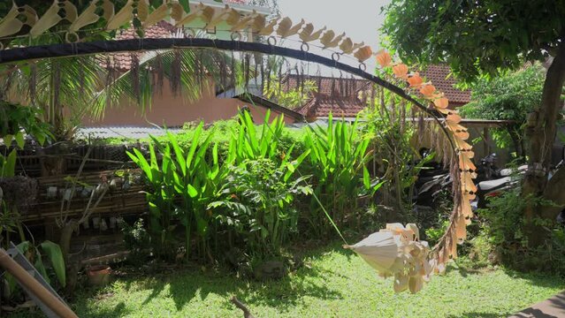 Beautiful live camera view of a traditional Dragon Tail bamboo pole as ornament to decorate the street on the Galungan holiday for Hindu people of Bali. Balinese ceremonial decoration.