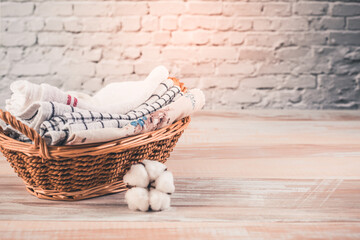 A stack of organic kitchen towels in a basket with cotton flower. Concept of sustainability