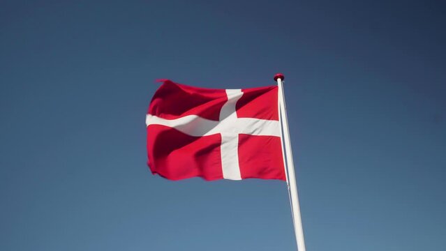 Denmark Flag Waving in the Wind in Slow Motion Close Up with blue sky background. 4k