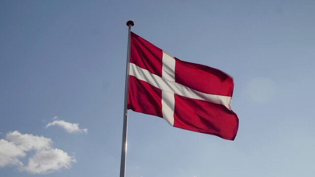 Denmark Flag Waving in the Wind in Slow Motion Close Up with blue sky with clouds background. 4k