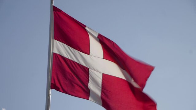 Close Up Denmark Flag Waving in the Wind in Slow Motion Close Up with blue sky background. 4k