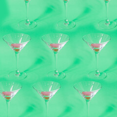 Pattern of cocktail glasses with pink liquid on green background. Concept of luxury relax with beverage on the beach. - 520965067