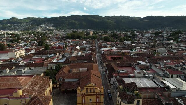 drone shot showing frontally the descent towards one of the main churches of san cristobal de las casas in mexico