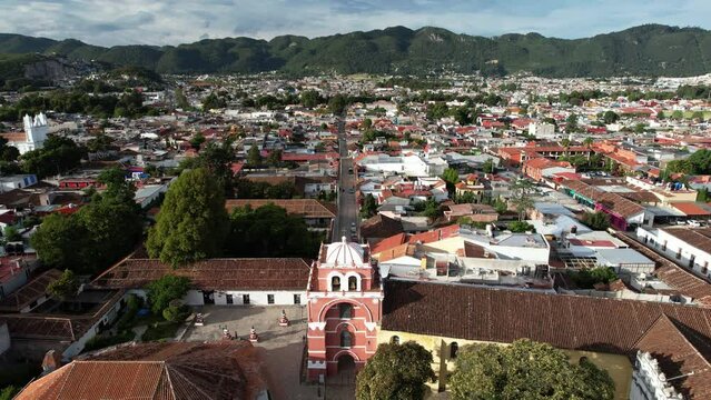 drone shot descending showing the moorish style arch of the city of san cristobal de las casa in chiapas mexico