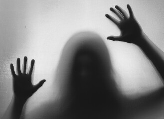 Shadowy figure behind glass - horror background