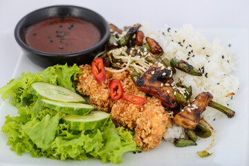 rice with teriyaki chicken and vegetables on a white plate
