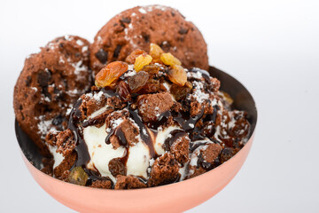 dessert scoops of ice cream with cookies in a glass on a white background macro photo
