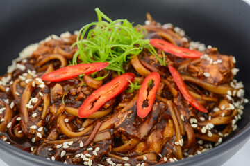 Korean dish buckwheat noodles in a black plate macro photo
