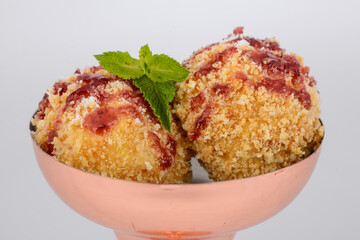 dessert balls in batter in a glass on a white background macro photo
