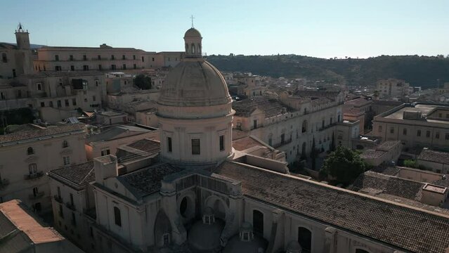 flying backwards from dome of cathedral revealing baroque town of Noto in Sicily