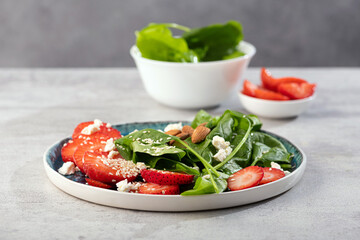 Fresh salad with strawberry fruit, almond, spinach and cottage cheese