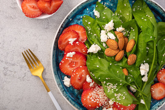 Fresh salad with strawberry fruit, almond, spinach and cottage cheese