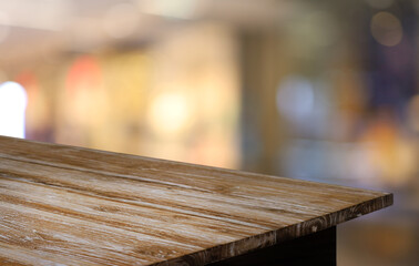 Wood table top in front of abstract blurred background. Empty wooden table space for text marketing promotion. blank wood table surface copy space