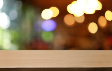 Empty wooden table in front of abstract blurred background of coffee shop . can be used for display or montage your products.Mock up for display of product