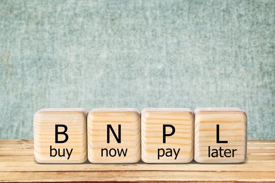 BNPL Text In Wooden Blocks. Buy Now Pay Later Concept On The Background