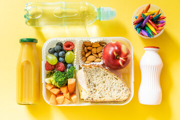 Back to school concept - school lunch with colorful pensils on yellow background