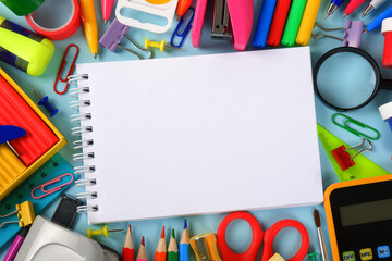 Colorful stationery, in the center-an empty notepad template on a blue background.Purchases of office supplies online through online stores, discounts and promotions for school,office supplies