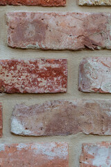 Background of a fragment of a wall of a red brick house. Texture of a brick wall.