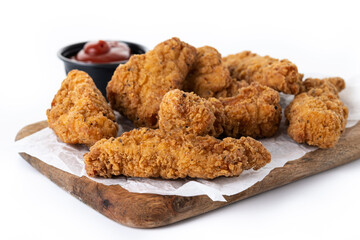 Crispy Kentucky fried chicken on cutting board isolated on white background