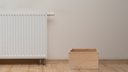 empty wooden box and Modern white radiator with thermostat background