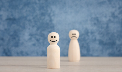 emotion faces on wooden doll for satisfaction survey