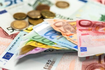 Euro in stationery band on pile of paper banknotes. Heap of money