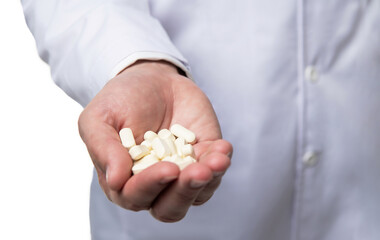 closeup of dietary medication. natural dietary supplement. doctors hand with dietary pills