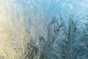 Frozen winter window with shiny ice frost pattern texture. Christmas wonder symbol, abstract background. Extreme north low temperature, natural Ice snow on frosty glass, cool winter weather outdoor