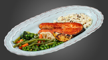 Grilled salmon steak with brown rice and vegetables.