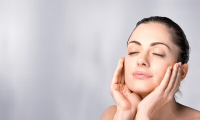 Naklejka premium Young woman touching painful throat against white background. throat, thyroid, medical, pain, sickness and healthcare concept.