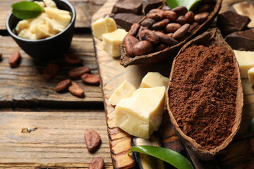 Composition with organic cocoa butter on wooden table, closeup