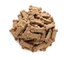 Pile of bone shaped dog cookies on white background, top view