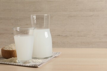 Natural rice water and grains on wooden table. Space for text