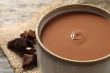 Yummy hot chocolate in mug on table, closeup
