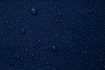 Many water drops on bright blue background
