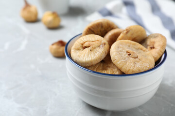 Tasty dried figs on light grey marble table, closeup