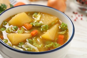 Bowl of delicious turnip soup on table, closeup view