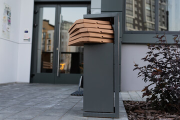 Cardboard boxes from eaten pizza in the trash at the entrance