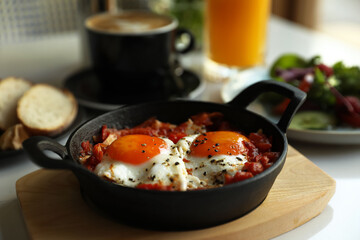 Tasty Shakshouka served on white table. Traditional Arabic dish