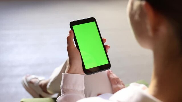 Close up view of girl looking at empty phone screen. People making online purchase, booking hotel, choosing goods and services. New app, ai concept
