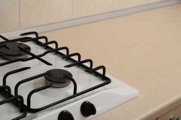 Modern gas cooktop in kitchen, closeup. Space for text