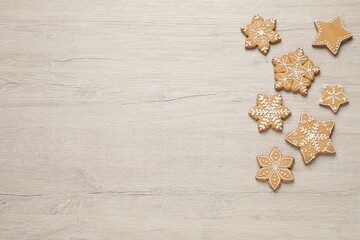 Fototapeta na wymiar Tasty Christmas cookies on beige wooden table, flat lay. Space for text