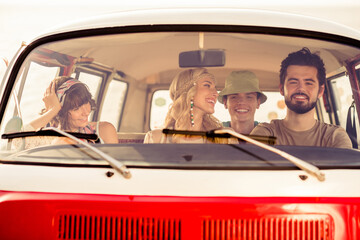 Portrait of group positive carefree people driving vintage van have good mood enjoy warm sunny...