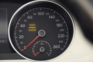 Closeup view of dashboard with warning icon check airbag system in car
