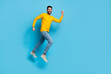 Fototapeta na wymiar Full size profile photo of cheerful excited person jump rush fast empty space isolated on blue color background