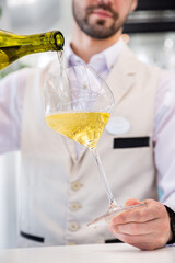 Man pours wine into a glass