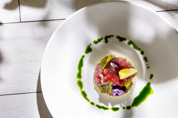 Salad with tuna, lemon, sorrel, violet, sesame, tobiko caviar, sauce, avocado, cucumber and mayonnaise