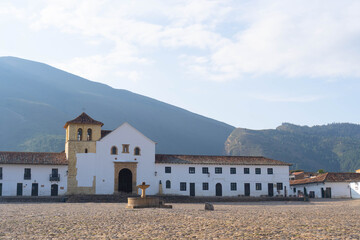 The cobblestone main square of Villa de Leyva with historical church of Villa de Leyva and colonial...